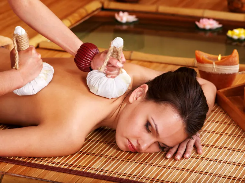 Thai herbal compress massage in Dubai — steamed herbal bundle therapy